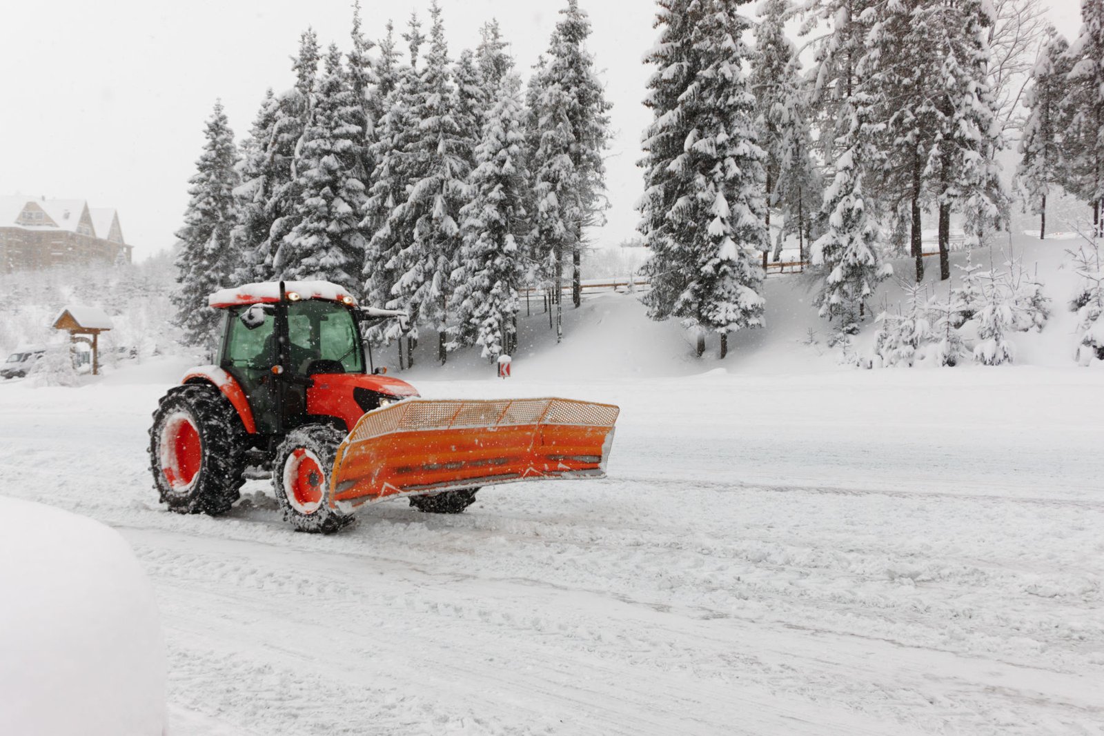 Snow plow clearing road after blizzard